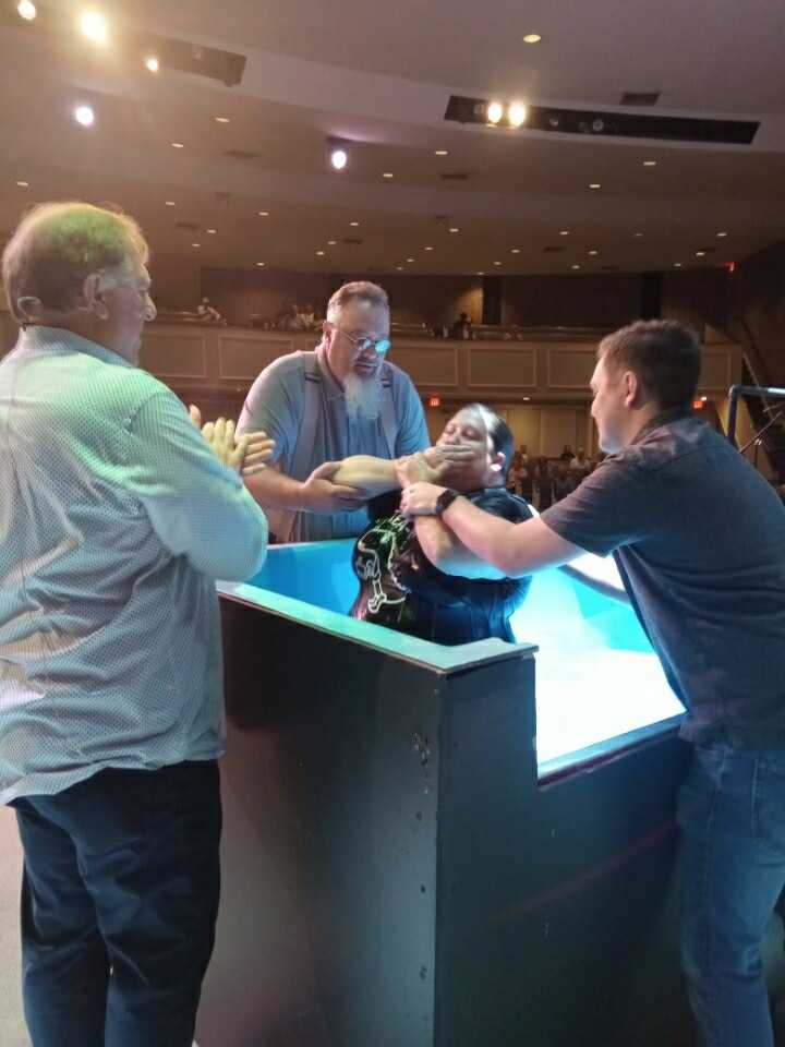 woman being baptized
